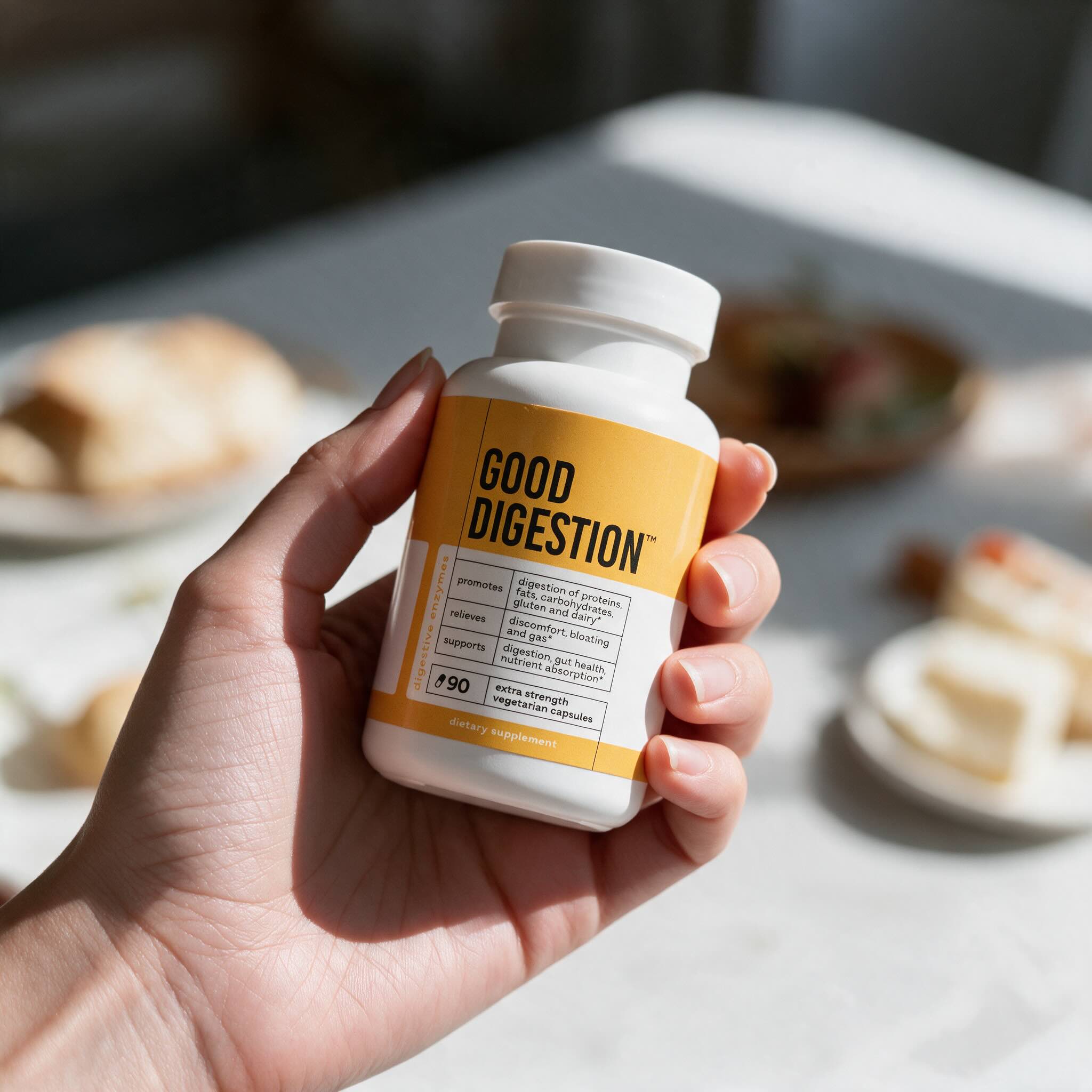 A hand holding the Good Digestion bottle in a bright kitchen